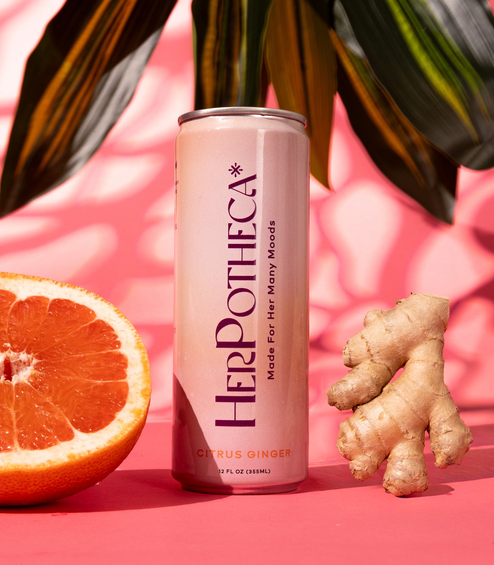 HerPotheca can with citrus and ginger on a pink background