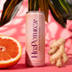 HerPotheca can with citrus and ginger on a pink background